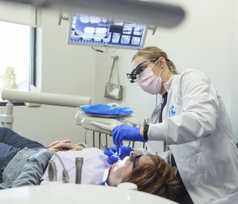 Woman looking at her smile during dental checkup and teeth cleaning visit