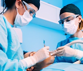 Dentist performing surgery