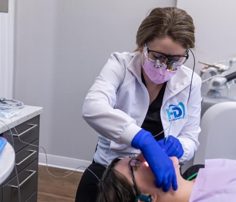 Smiling woman and dentist talking at biannual checkup