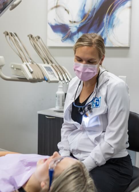 Woman sharing full smile after dental implant tooth replacement