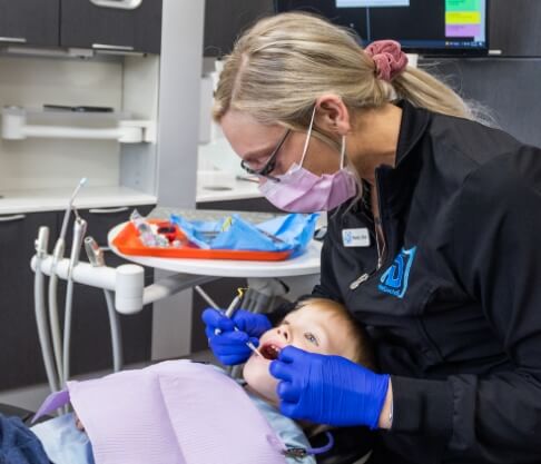 Parents and child in dental office for children's dentistry visit