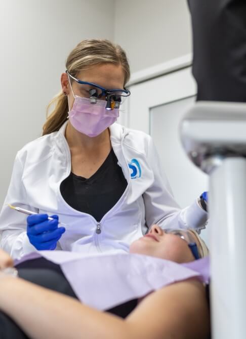 Man and woman smiling outdoors after preventive dentistry visit