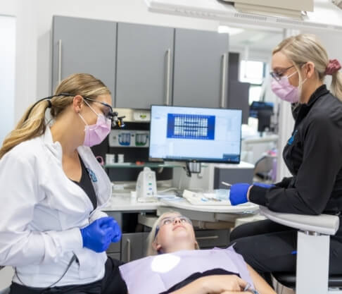 Woman receiving oral cancer screening