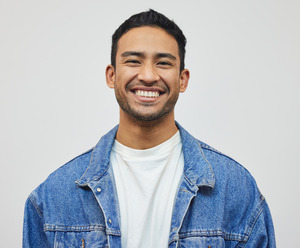 Man in a denim jacket smiling