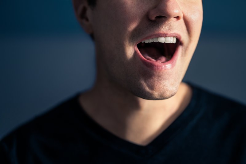 a man opening and stretching his mouth